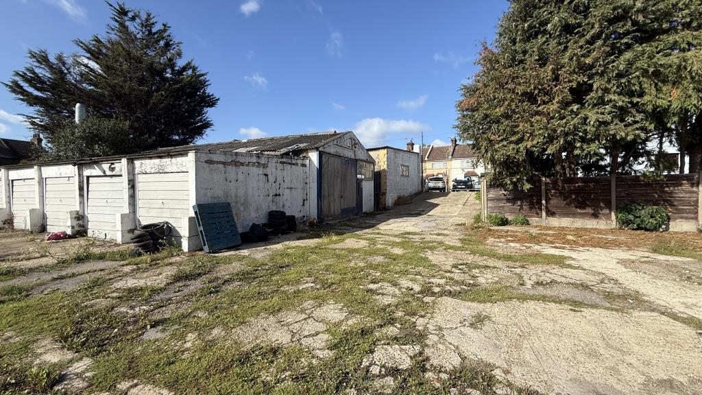 Lot: 34 - YARD, GARAGES AND LIGHT INDUSTRIAL PREMISES WITH POTENTIAL - External image of garage area another angle